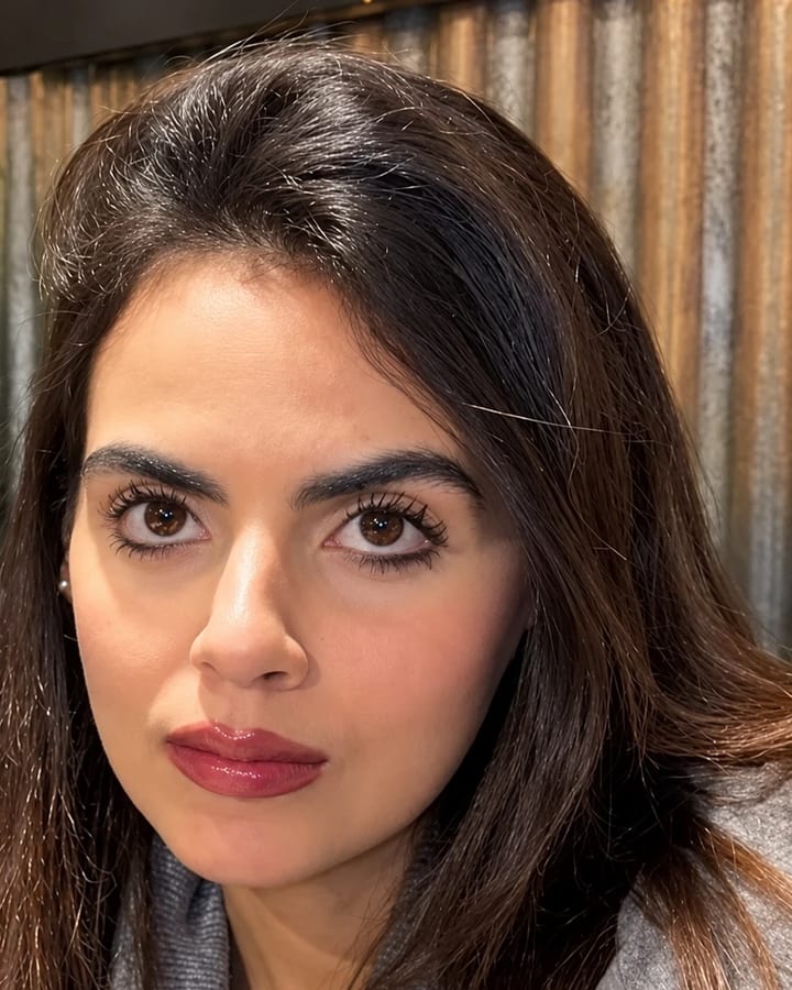 Portrait of Ghazaleh, a woman with long dark hair, looking directly at the camera.